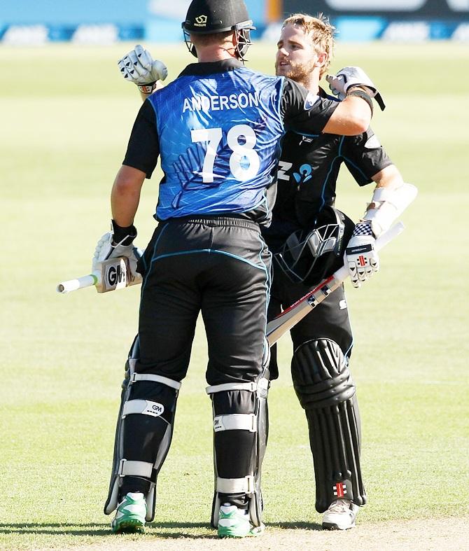 Kane Williamson of New Zealand celebrates scoring his century with Cory Anderson