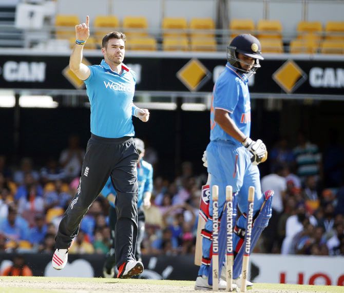 England's bowler James Anderson (left) reacts after bowling out India's Bhuvneshwar Kumar (right)