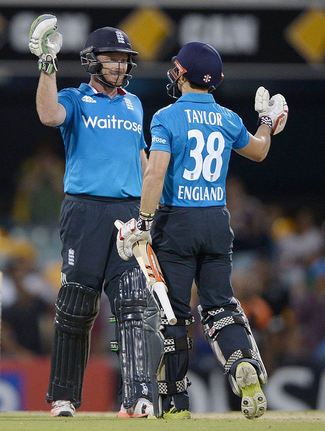 Ian Bell and James Taylor of England celebrate winning the 3rd One-Day International against India of the tri-series at The Gabba on Tuesday