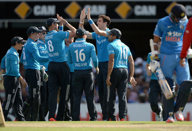 Steven Finn of England celebrates with teammates after dismissing Axar Patel of India at The Gabba on Tuesday