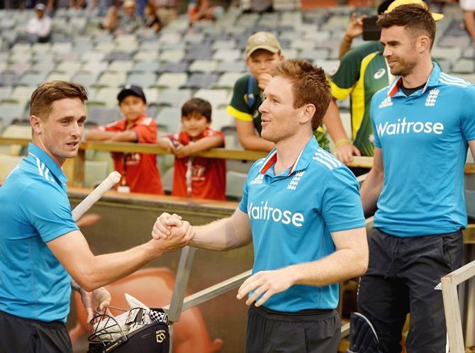 Chris Woakes of England shakes hands with captain Eoin Morgan after winning