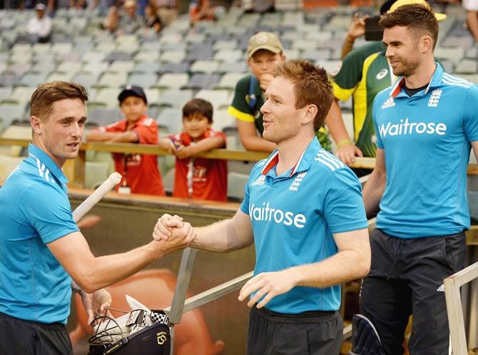 Chris Woakes of England greets captain Eoin Morgan after winning