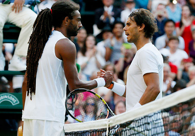 Germany's Dustin Brown shakes hands with Spain's Rafael Nadal after winning his match at Wimbledon on Thursday