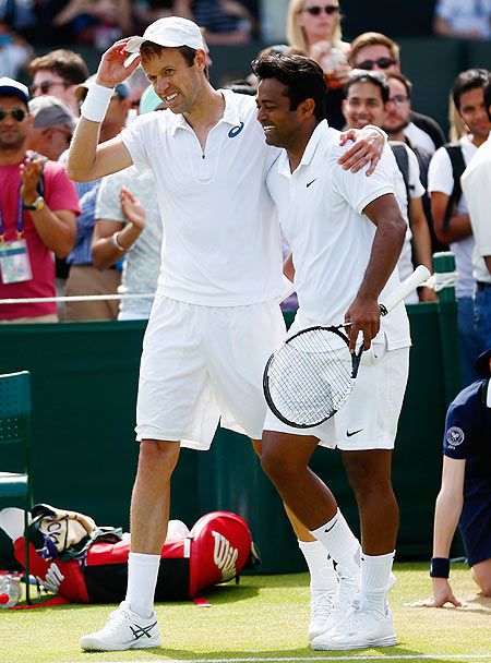 India's Leander Paes and his doubles partner Canadian Daniel Nestor celebrate after winning their Wimbledon second round doubles match against Russia's Teymuraz Gabashvili and Chinese Tapei's Yen-Hsun Lu at the All England Lawn Tennis and Croquet Club on Saturday
