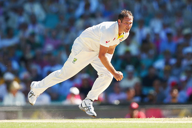 Australia's Ryan Harris follows through after bowling a delivery