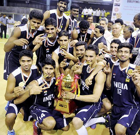 Indian basketball players celebrate after defeating Sri Lanka in final of the 4th South Asian Basketball championship in Bengaluru on Sunday