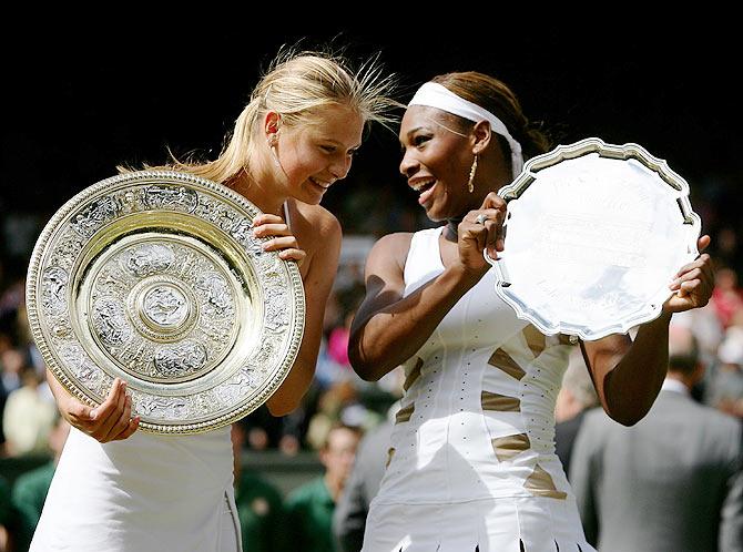 Russia's Maria Sharapova poses with her trophy after beating USA's Serena Williams in the Wimbledon final on July 3, 2004 at the All England Lawn Tennis and Croquet Club in London