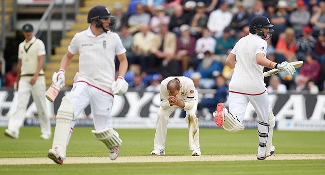 Australia bowler Nathan Lyon (centre) reacts as Joe Root and Gary Ballance pick up runs