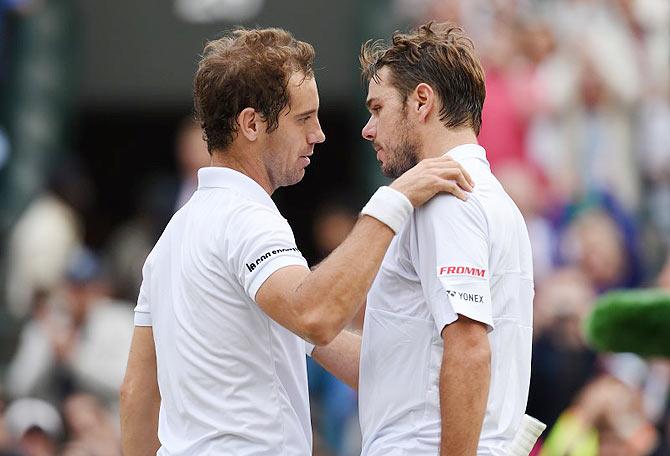 Richard Gasquet embraces Stanislas Wawrinka after winning his quarter-final match