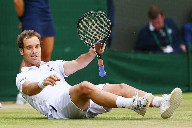 France's Richard Gasquet celebrates at match point after winning his Wimbledon quarter-final against Switzerland's Stanislas Wawrinka at the All England Lawn Tennis and Croquet Club on Wednesday