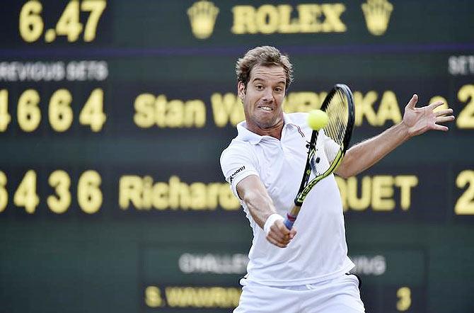 Richard Gasquet plays his trademark backhand during his match against Stanislas Wawrinka