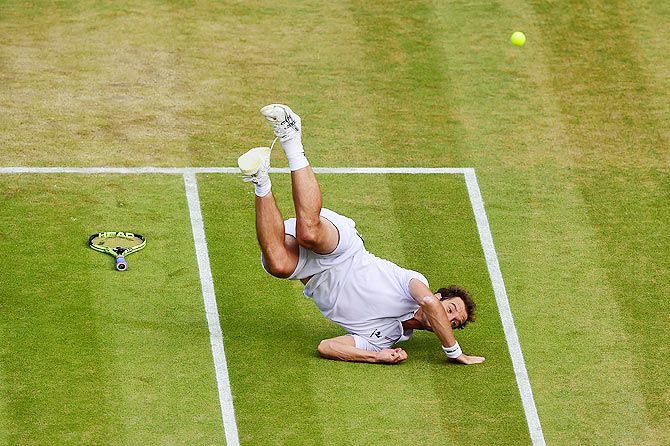 Richard Gasquet slips during his Wimbledon quarter-final against Stanislas Wawrinka on Wednesday