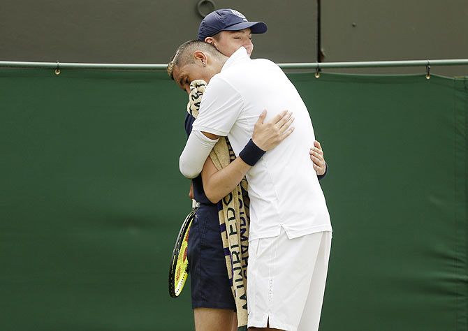 Australia's Nick Kyrgios hugs a ball boy during his match against Frenchman Richard Gasquet at the Wimbledon Tennis Championships on Monday