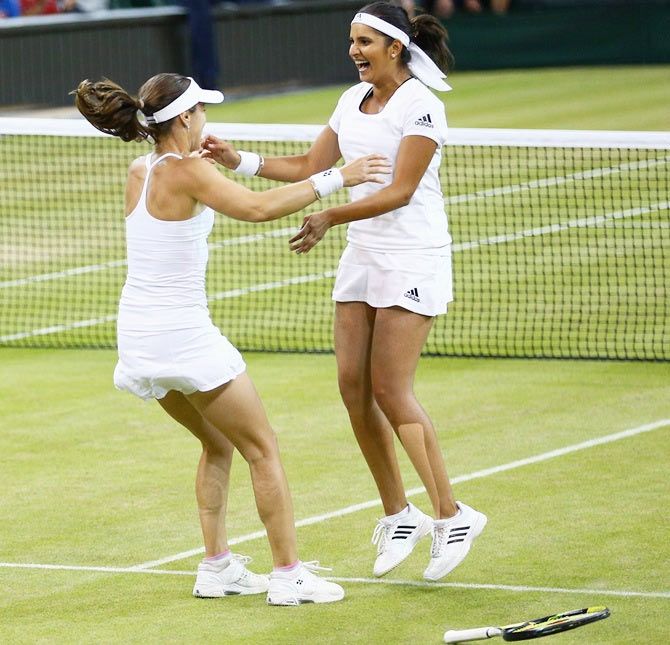 India's Sania Mirza (right) and Switzerland's Martina Hingis are ecstatic on winning their Wimbledon doubles title on Saturday