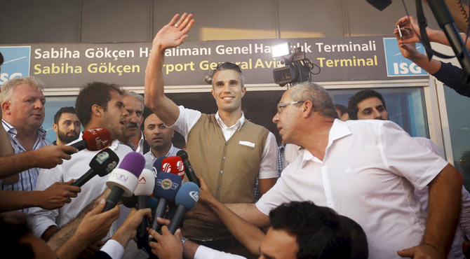 Netherlands striker Robin van Persie greets Fenerbahce supporters