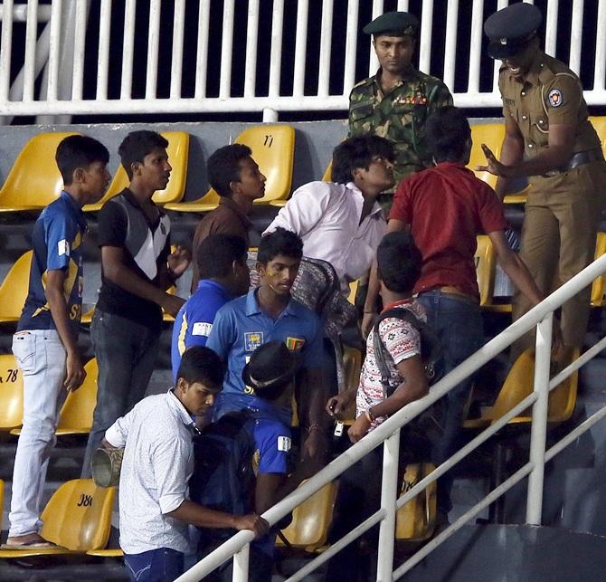 Supporters argue with a police officer