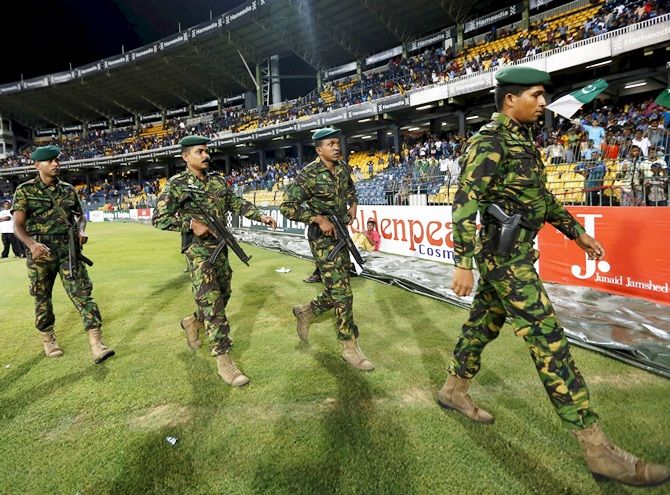 Sri Lanka's Special Task Force soldiers walk towards Pakistan's cricket team's dressing room after the team walked off field 