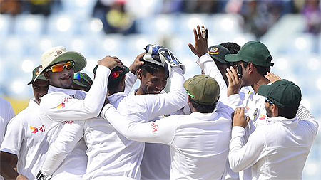 Bangladesh bowler Mustafizur Rahman is congratulated by teammates after picking a wicket on Day 1 of the first Test against South Africa at Chittagong on Tuesday
