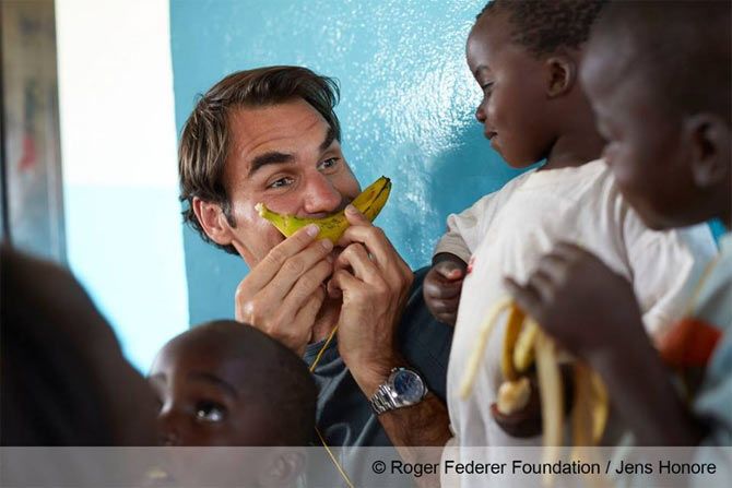 Swiss tennis giant Roger Federer jokes around with kids at his charity event in Malawi on Monday