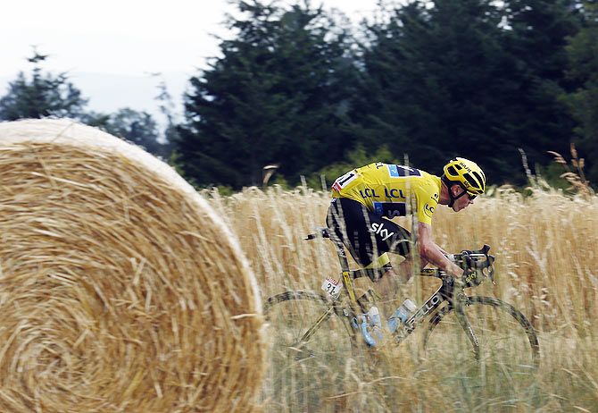 Team Sky rider Chris Froome of Britain wears the race leader's yellow jersey as he cycles during the 178.5-km (110.9 miles) 14th stage of the Tour de France from Rodez to Mende, France, on July 18