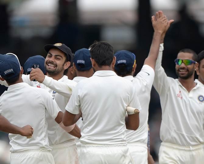 Team India celebrates the fall of a wicket