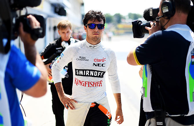 Force India's Sergio Perez of Mexico returns to the pit lane after crashing during practice at the Hungarian Formula One Grand Prix at Hungaroring in Budapest on Friday