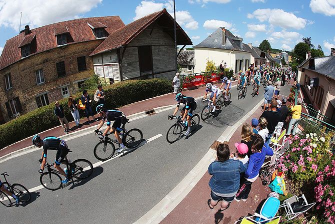 Chris Froome of Great Britain and Team Sky (left) rides with the peloton as they are cheered on by spectators during Stage 6 of the Tour de France, a 191.5km stage between Abbeville and Le Havre, in Grandcourt, France, on July 9