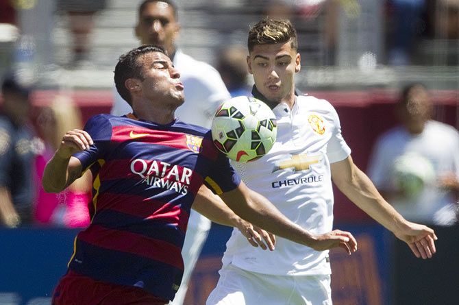 Manchester United's Andreas Pereira (right) challenges Barcelona's Pedro