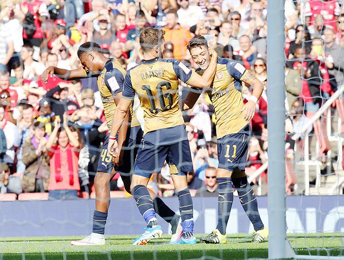 Arsenal's Mesut Ozil celebrates scoring their fifth goal