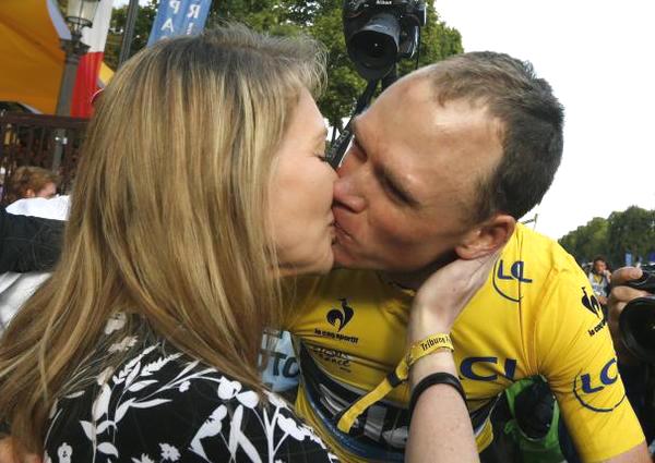 Team Sky rider Chris Froome of Britain (right), the race leader's yellow jersey, is kissed by his wife Michelle as he celebrates his victory after the 109.5-km (68 miles) final 21st stage of the 102nd Tour de France cycling race from Sevres to Paris Champs-Elysees on Sunday