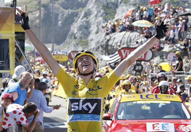 Team Sky rider Chris Froome of Britain, race leader's yellow jersey, celebrates as he crosses the finish line to win the 167-km (103.7 miles) 10th stage