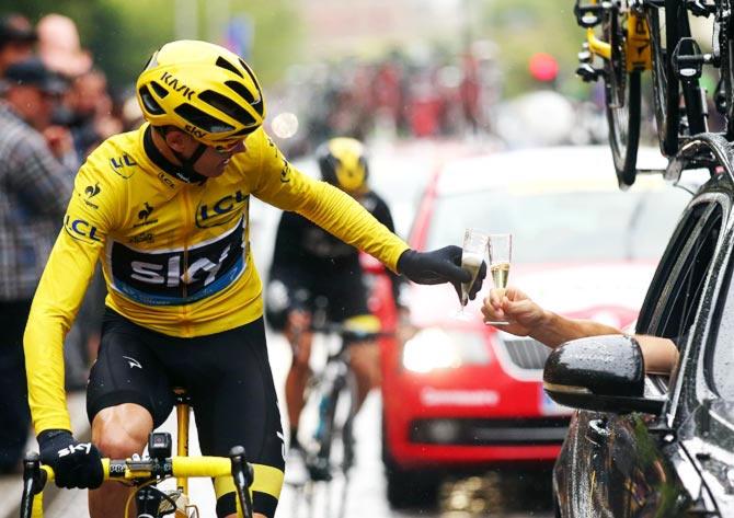 Chris Froome (left) celebrates his Tour de France victory with Team Sky on July 26