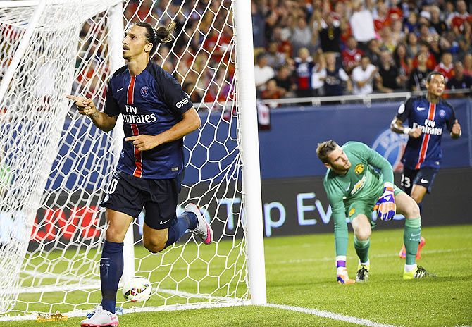 Paris Saint-Germain forward Zlatan Ibrahimovic (10) scores a goal against Manchester United goalkeeper David De Gea (1) during the first half at Soldier Field