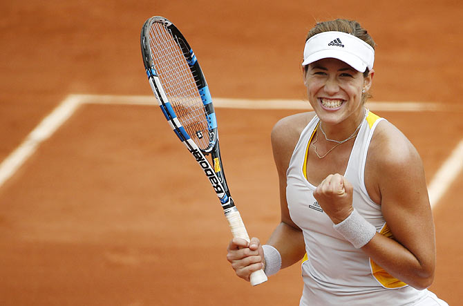 Spain's Garbine Muguruza celebrates after defeating Italy's Flavia Pennetta