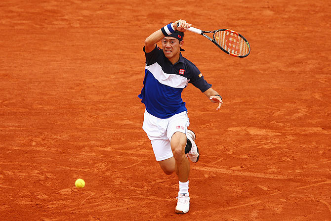 Japan's Kei Nishikori returns a shot against Russia's Teymuraz Gabashvili