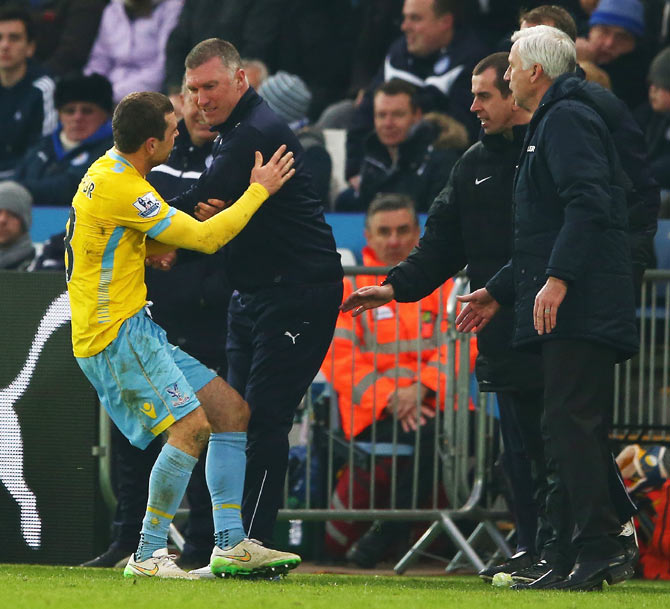 Leicester City manager Nigel Pearson exchanges words with Crystal Palace's James McArthur as Alan Pardew, manager of Crystal Palace looks on during their English Premier League match on February 7, 2015