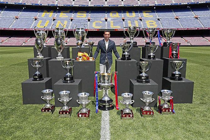 Xavi Hernandez with the trophies he has won during his career at FC Barcelona