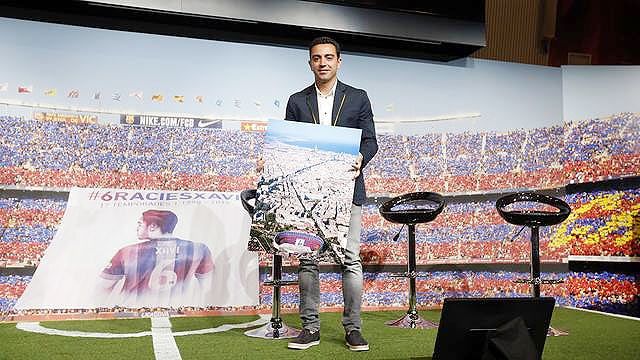 Xavi Hernandez poses during his institutional tribute at Camp Nou on Wednesday