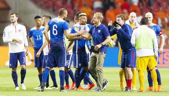 Team US celebrate with headcoach Jurgen Klinsmann after their victory over the Netherlands in a football friendly match at the Amsterdam Arena in Amsterdam, the Netherlands on Saturday