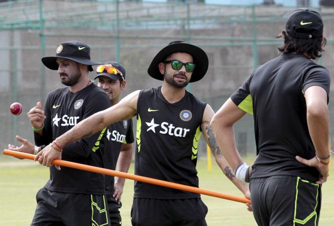 India's Harbhajan Singh (left), captain Virat Kohli (left)