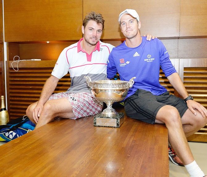 Switzerland's Stanislas Wawrinka poses with the Coupe de Mousquetaires and coach Magnus Norman after winning the French Open