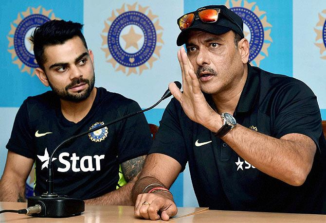 Indian Cricket Team Director Ravi Shastri and captain Virat Kohli interact at a media conference