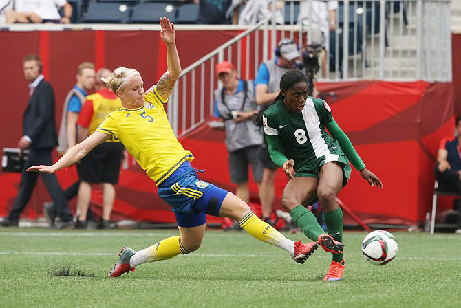 Nigeria forward Asisat Oshoala (8) scores past Sweden defender Nilla Fischer (5) in their Group D match at the 2015 women's World Cup at Winnipeg Stadium on Monday