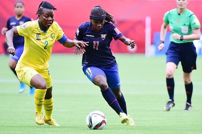 Cameroon defender Christine Manie (left) and Ecuador forward Monica Quinteros (11) vie for possession