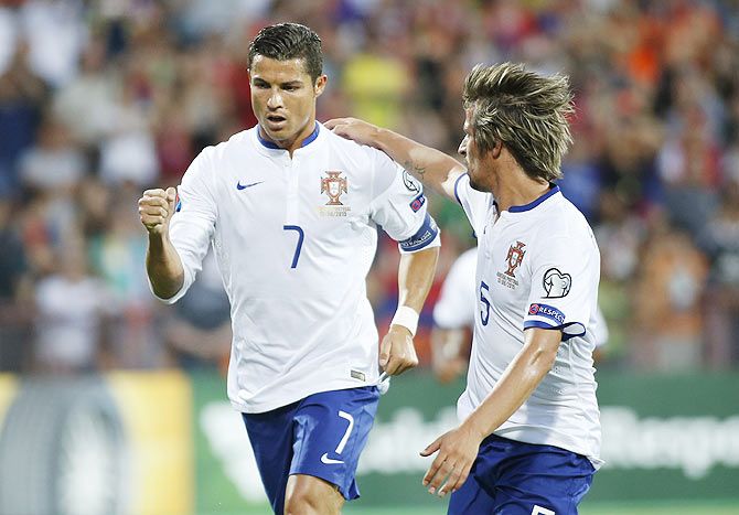 Portugal's Cristiano Ronaldo celebrates with teammate Fabio Coentrao (right) after scoring a penalty against Armenia during their Euro 2016 group I qualifying match in Yerevan, Armenia on Saturday