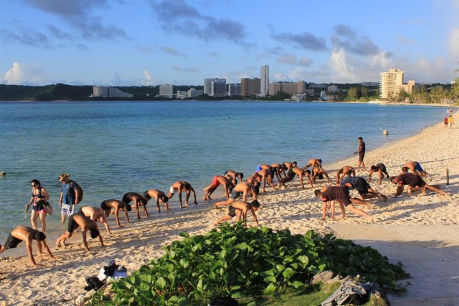 Players of the Indian football team stretch on the beach in Guam on Sunday