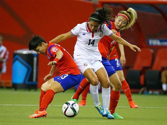 Costa Rica forward Maria Barrantes (14) battles for the ball with Korea Republic midfielder Kwon Hahnul (13) and midfielder Cho Sohyun (8) during the second half of their Group E soccer match in Montreal