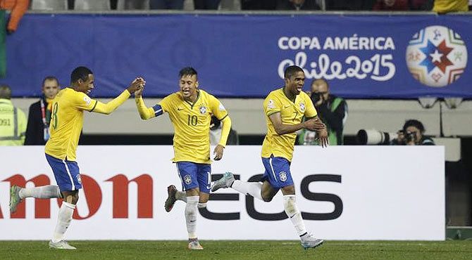 Brazil's Douglas (right) celebrates with teammates Neymar (10) and Elias after scoring against Peru during their first round Copa America match at Estadio Municipal Bicentenario German Becker in Temuco, Chile on Sunday