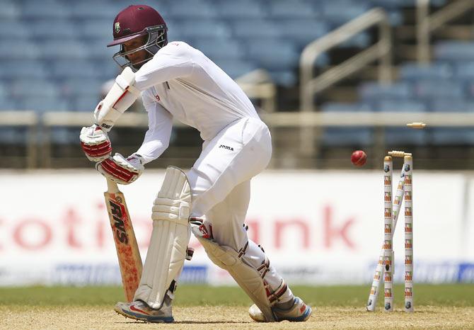 Shai Hope is bowled by Mitchell Johnson