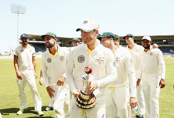 The Australian cricket team celebrates with the Frank Worrell Trophy after defeating West Indies